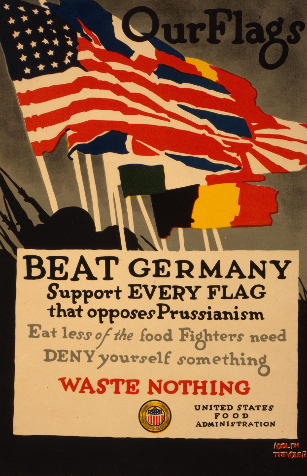 Ein Plakat mit einer rot-weiß-blauen Flagge mit einem weißen Stern und einer schwarzen, fetten Schrift, die lautet: "Unsere Flaggen schlagen Deutschland - Unterstützt jede Flagge, die gegen Preußentum kämpft", mit einem weißen Rand um den Text.