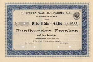 Ein altes deutsches Aktienzertifikat mit blauer Umrandung und der Aufschrift "Schweiz Wagons-Fabrik A.G."