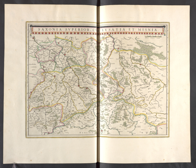 Eine detaillierte Karte von Sachsen, die seine Provinzen und Städte zeigt, auf einem offenen Buch gegen einem schwarzen Hintergrund.